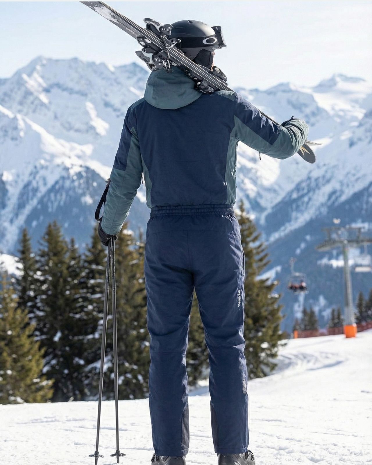 Person in ski gear with skis on a snowy mountain slope