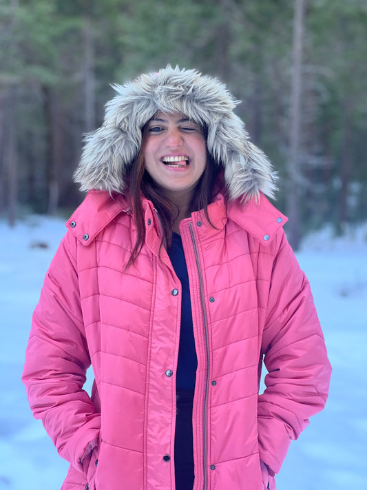 A woman in the snow, enjoying in Kosha's warm cozy layers!