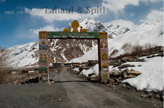 Scenic view of Lahaul and Spiti Valley with rugged mountains and a picturesque gate reading 'Welcome' against a stunning natural backdrop.