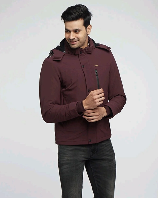 Man wearing maroon Kosha winter jacket with hood.