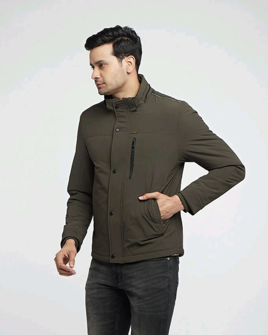 Man wearing an olive green winter jacket from Kosha, styled with black jeans.