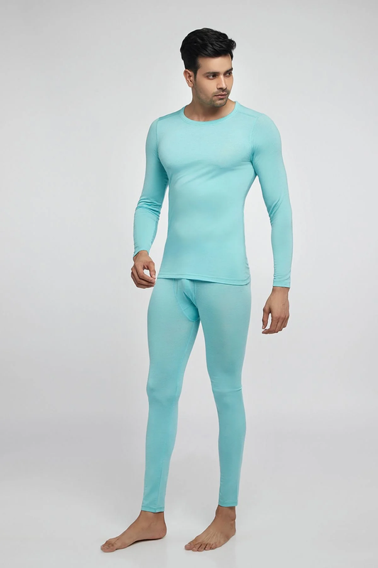 A man wearing Kosha’s lightweight aqua blue thermal tops and bottoms, including long-sleeve tops and full-length leggings, showcasing the product’s fit and style.