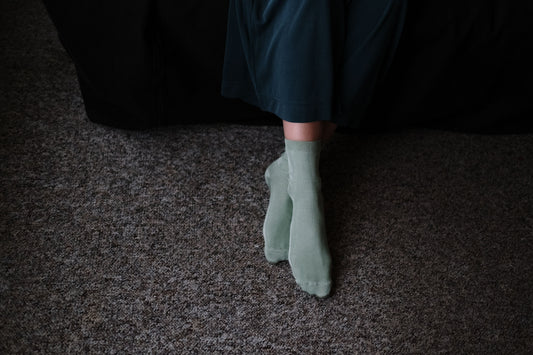 Photo by cottonbro studio of a woman in socks on rug at home
