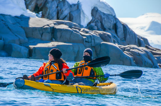 Photo of two people boating in Antarctica by Karson