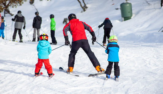 Photo by Macourt Media of people skiing on snow covered ground