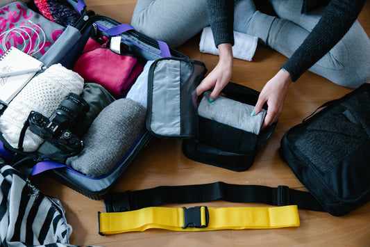Photo of an unrecognizable person packing clothes by Timur Weber 