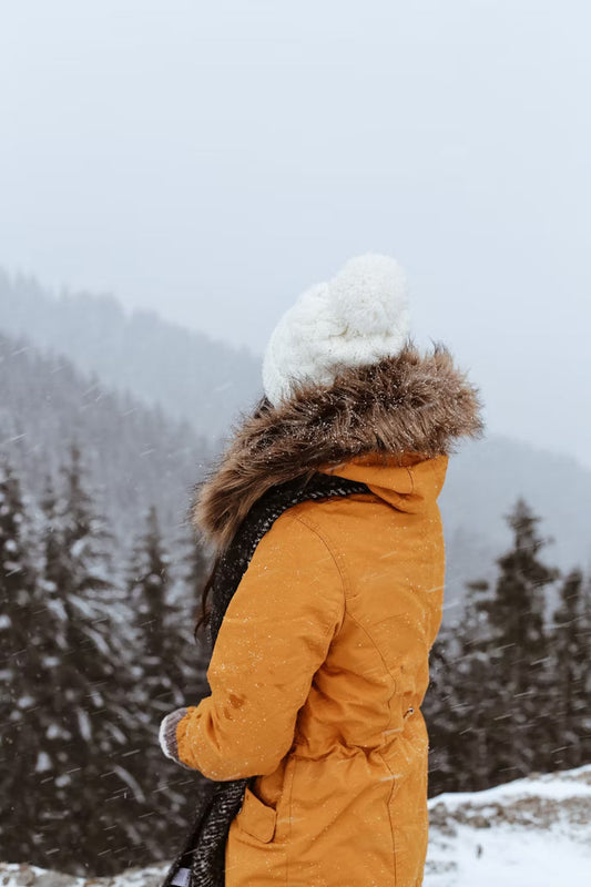 A woman in Kosha's packable puffer jacket for women.