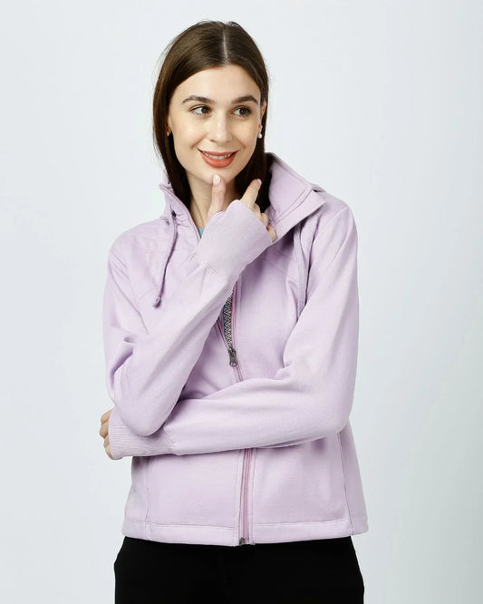 Woman wearing a lavender full-zip winter jacket with thumbhole cuffs, showcasing Kosha’s blend of comfort and style in breathable cold weather gear.