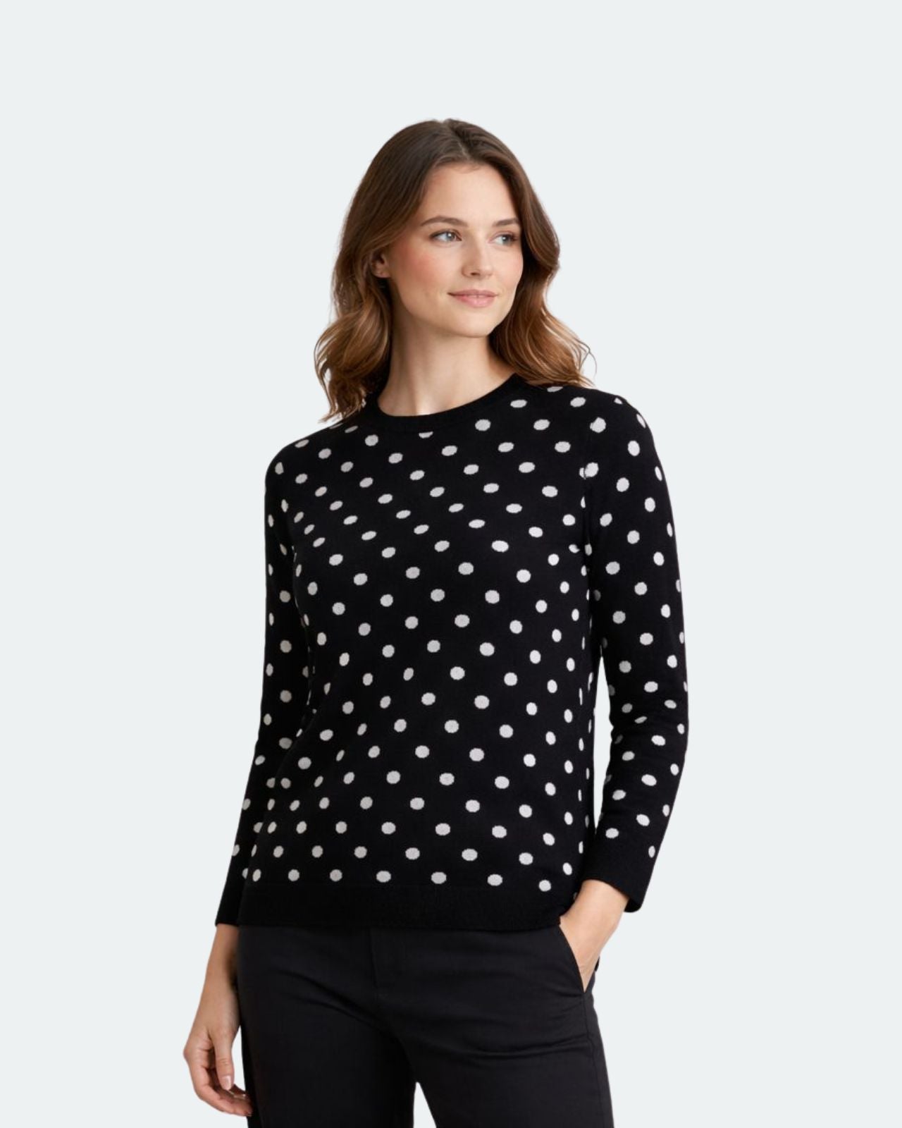 Woman wearing a black sweater with white polka dots