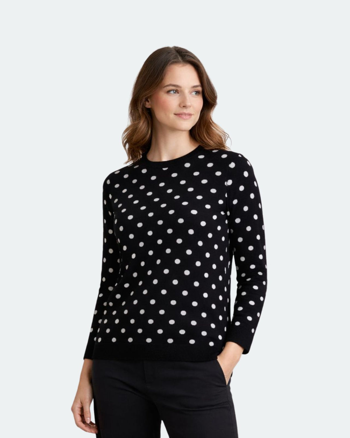 Woman wearing a black sweater with white polka dots